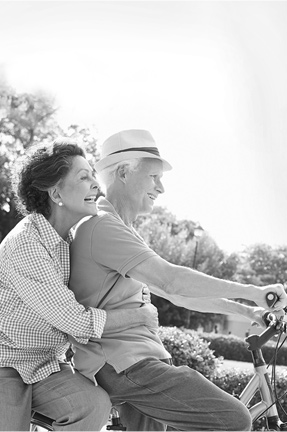 senior Hispanic Couple Riding Bikes in Park